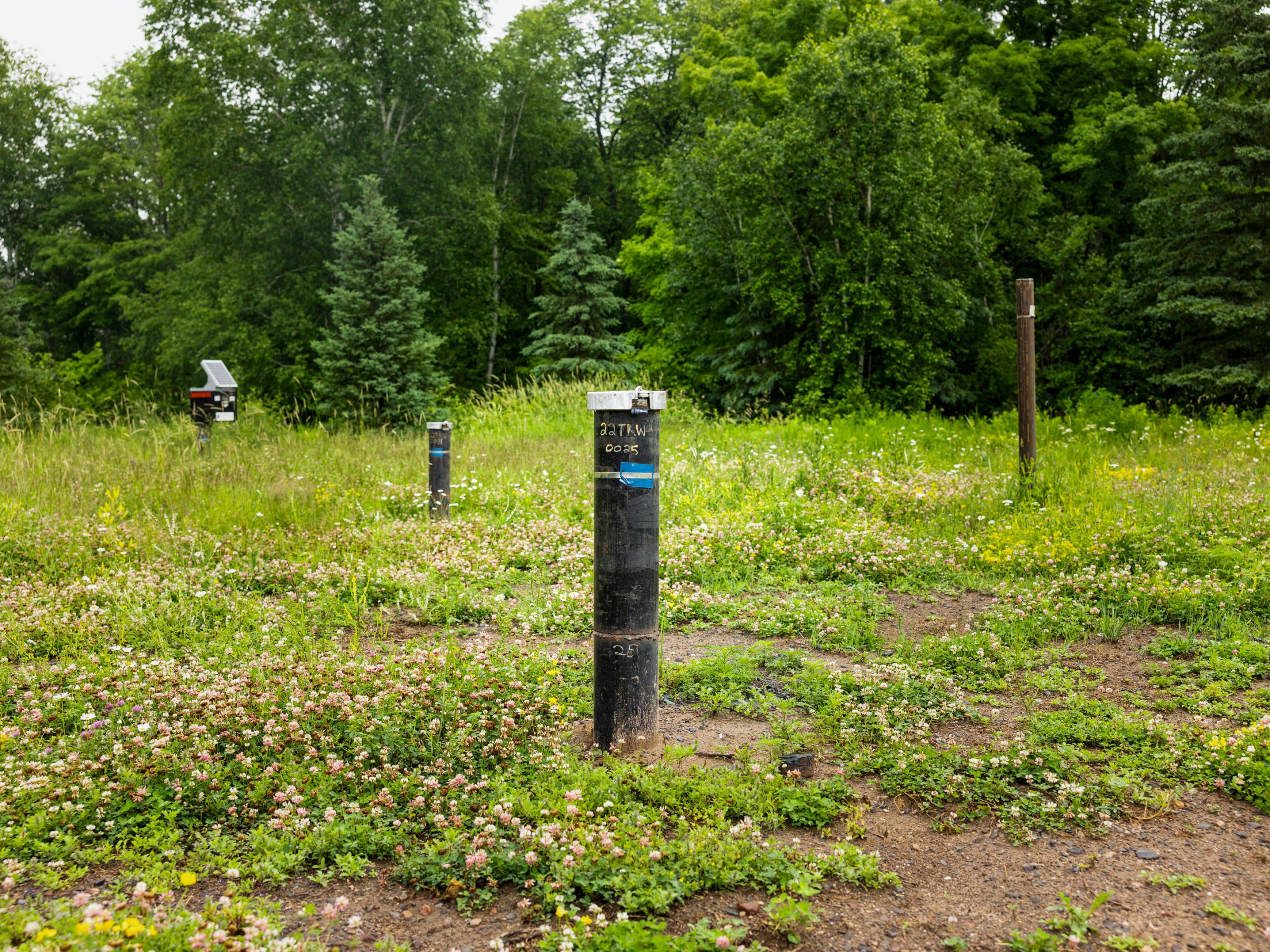 labelled pipes stick up from the ground