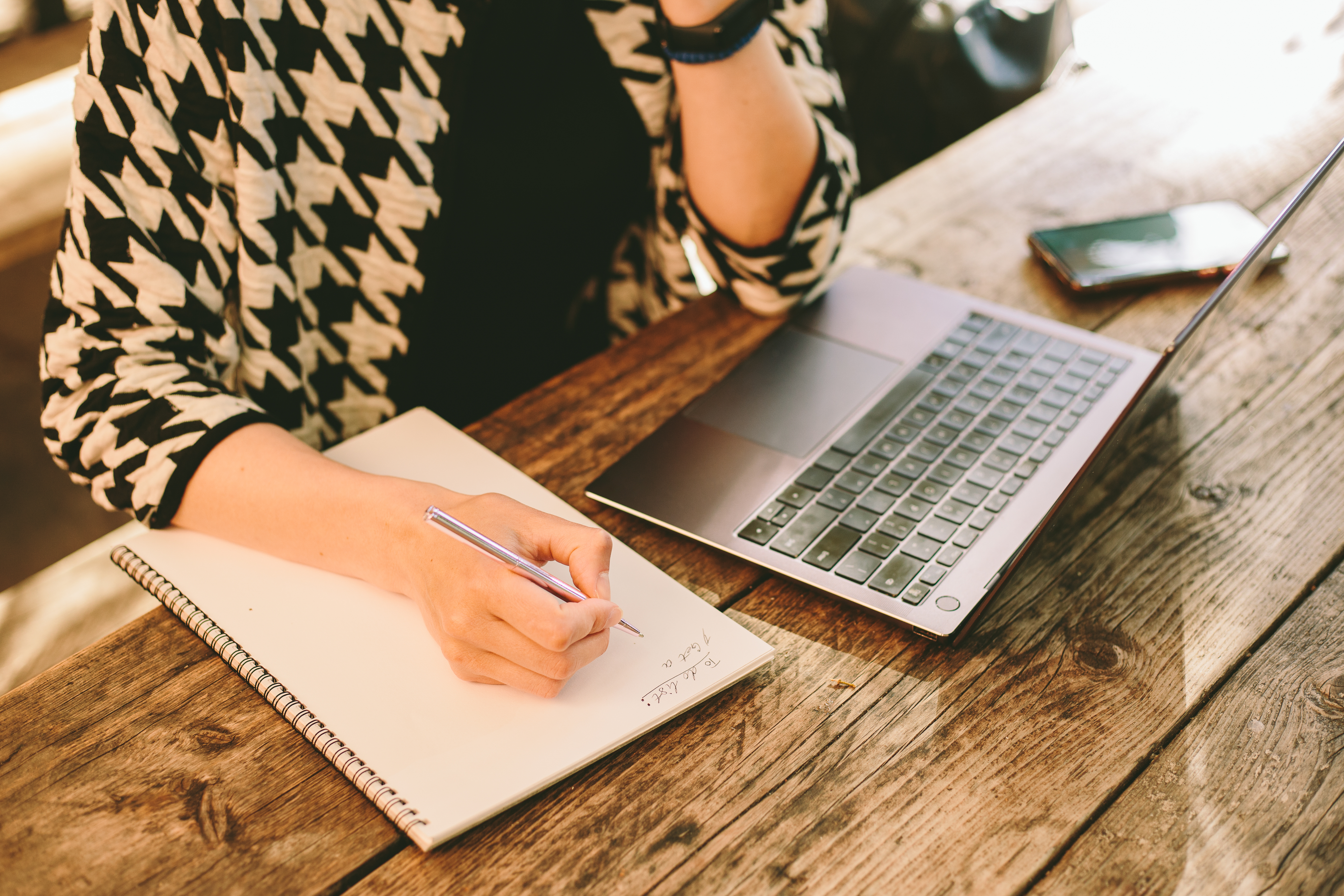 Close up of woman&#039;s hand writing a to-do list