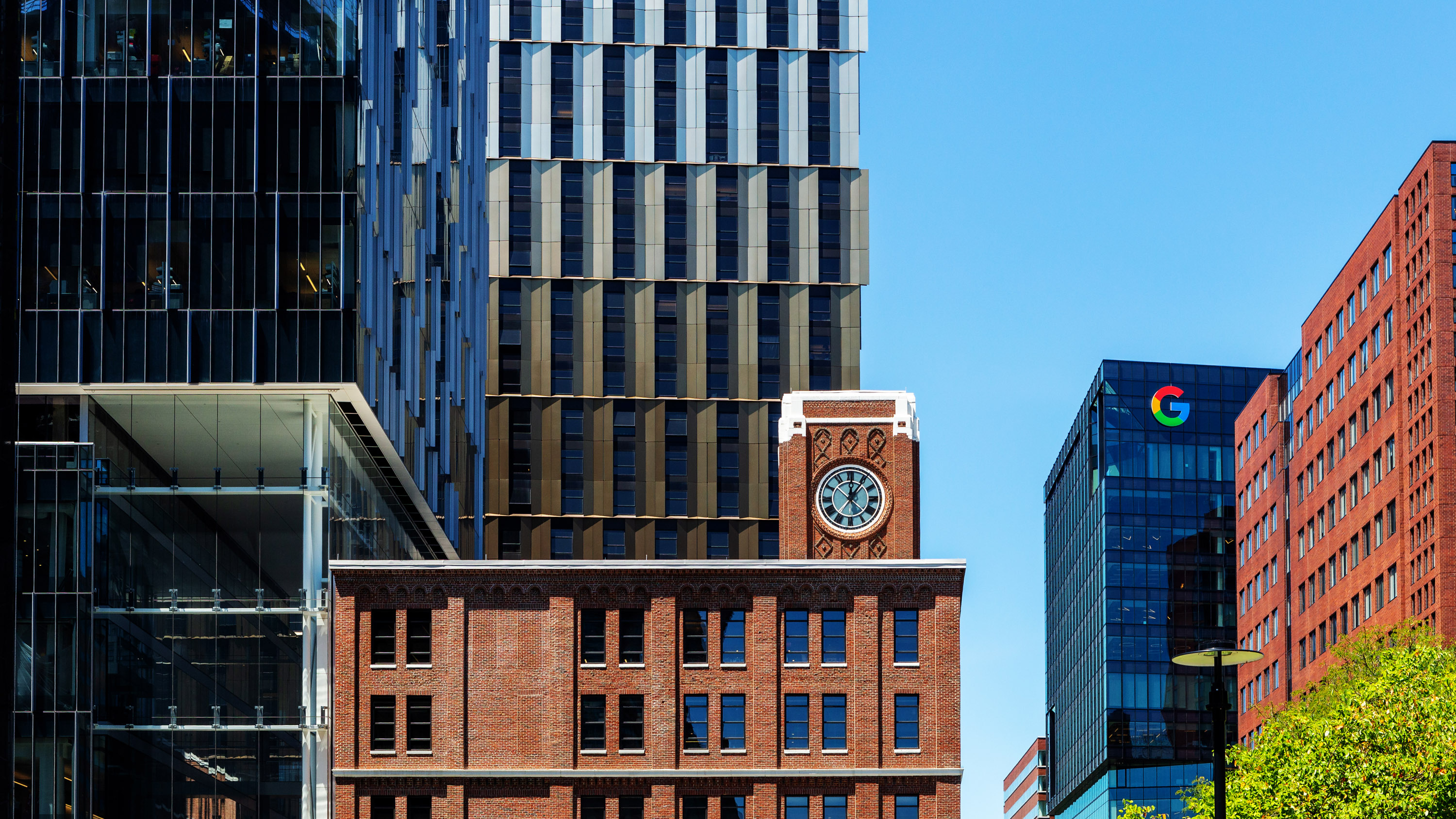 view of the skyline in Kendall Square, Cambridge with new glass towers including one for Google mixed in with older brick and collegiate buildings