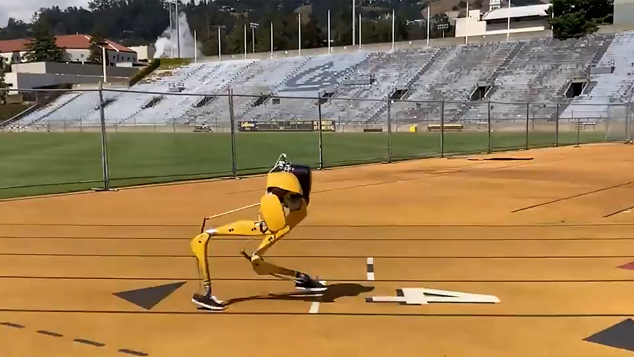 screenshot of a bipedal robot in lane 4 of an outdoor running track